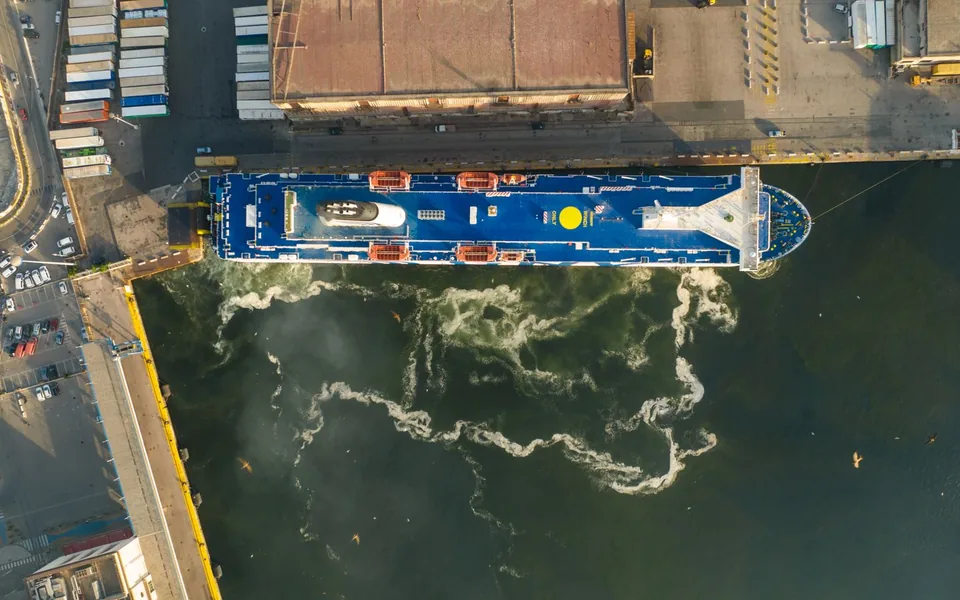 Overhead view of a freight vessel moored at an industrial port