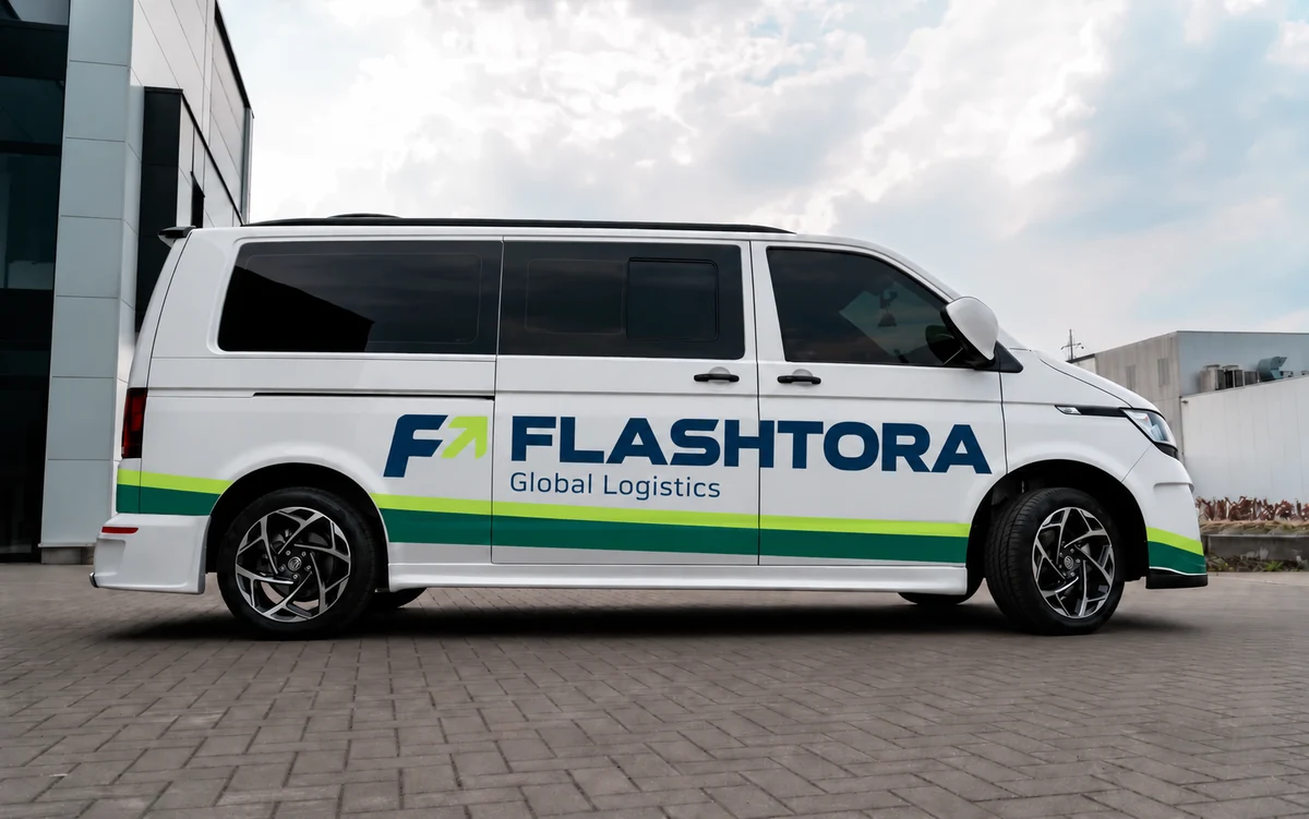 White van with FLASHTORA lettering and green and lime graphics along its side