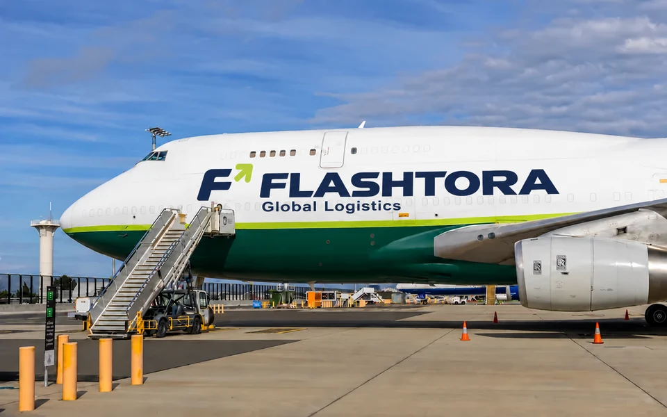 FLASHTORA lettering on a white aircraft at an airport