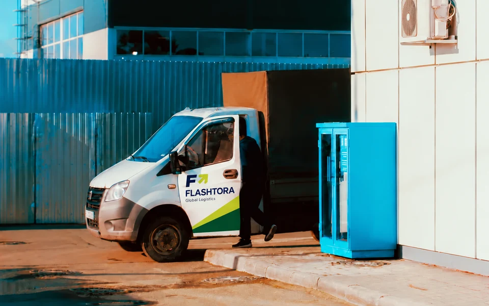 FLASHTORA branding on a delivery vehicle beside a warehouse loading bay