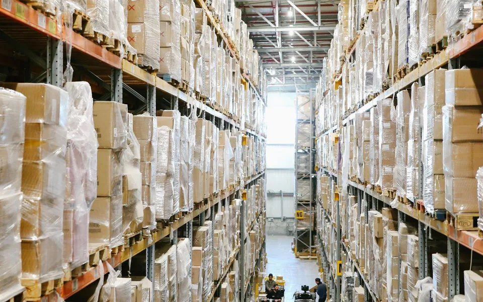 Warehouse aisle lined with pallet racks and boxed inventory